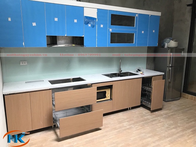 Tủ bếp gỗ acrylic với tủ bếp trên cánh acrylic màu trắng. Tủ bếp dưới là laminate tại nhà chị Quỳnh, Hoài Đức, Hà Nội